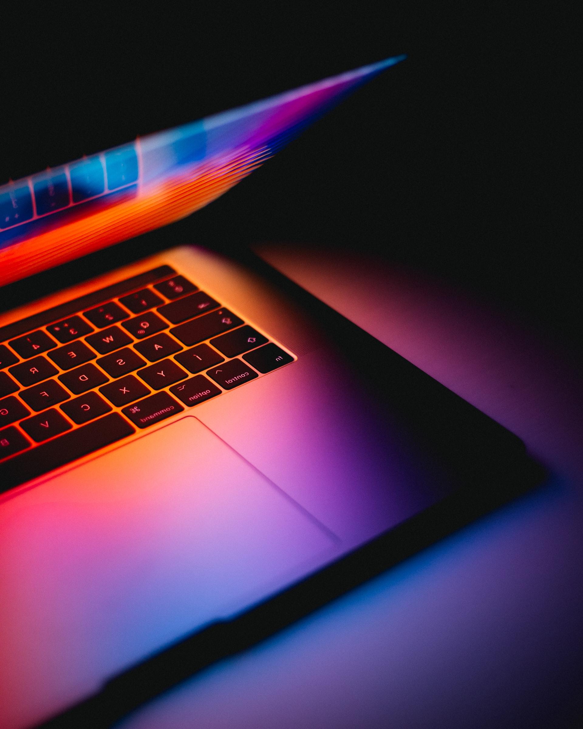 Computer lit by a colorful screen